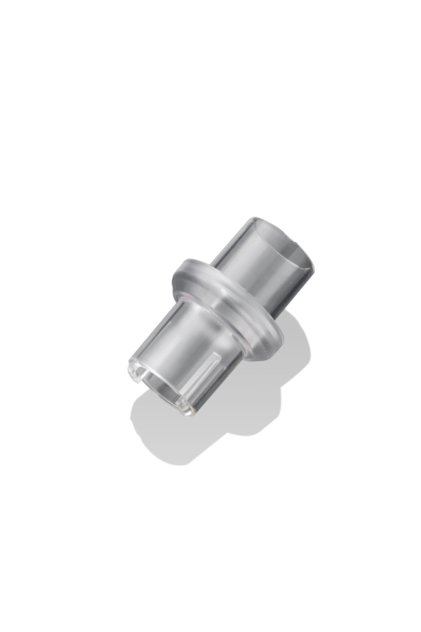 Clear plastic medical connector with a flared middle section, isolated on a black background.