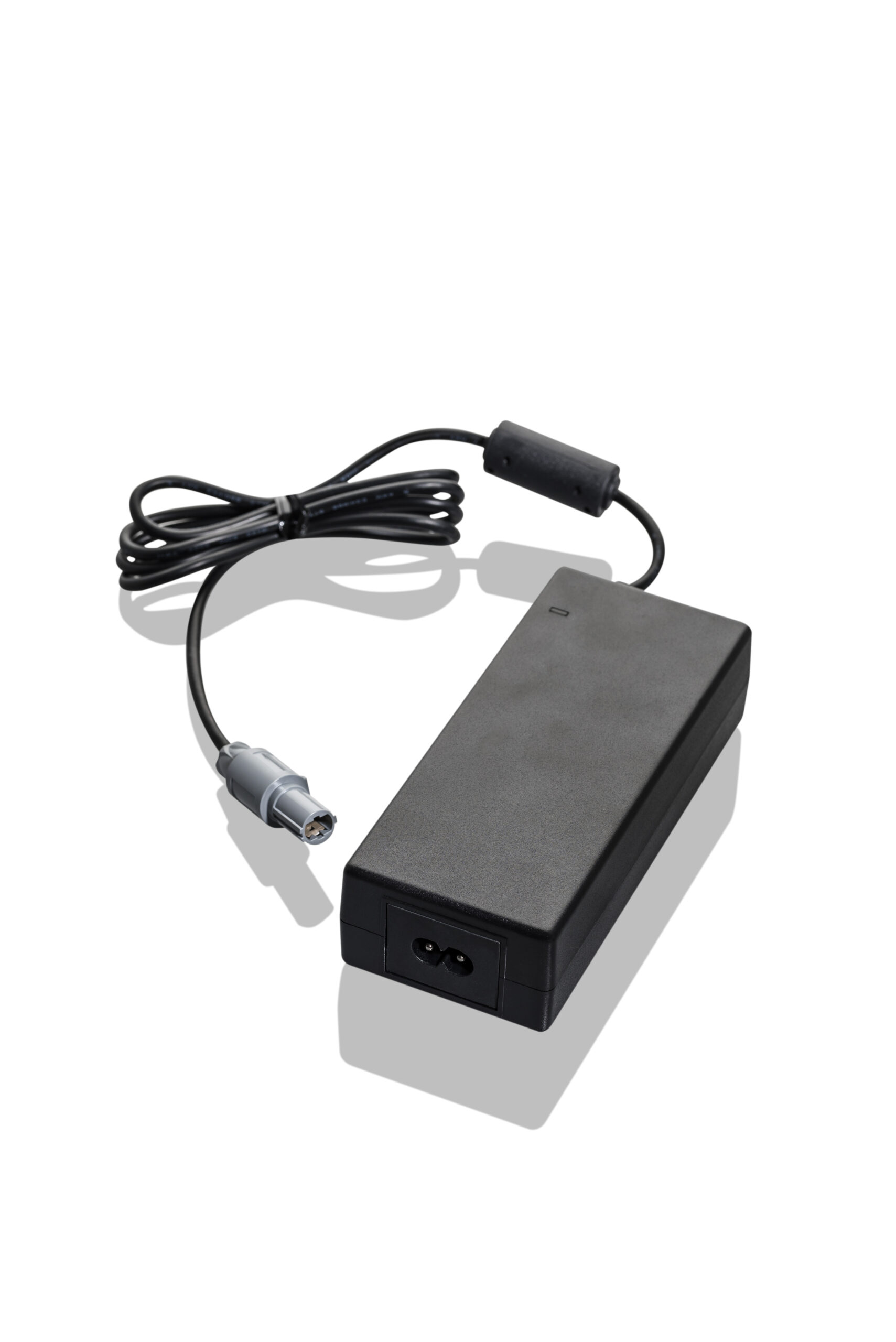Black rectangular power adapter with attached cable and connector on white background.