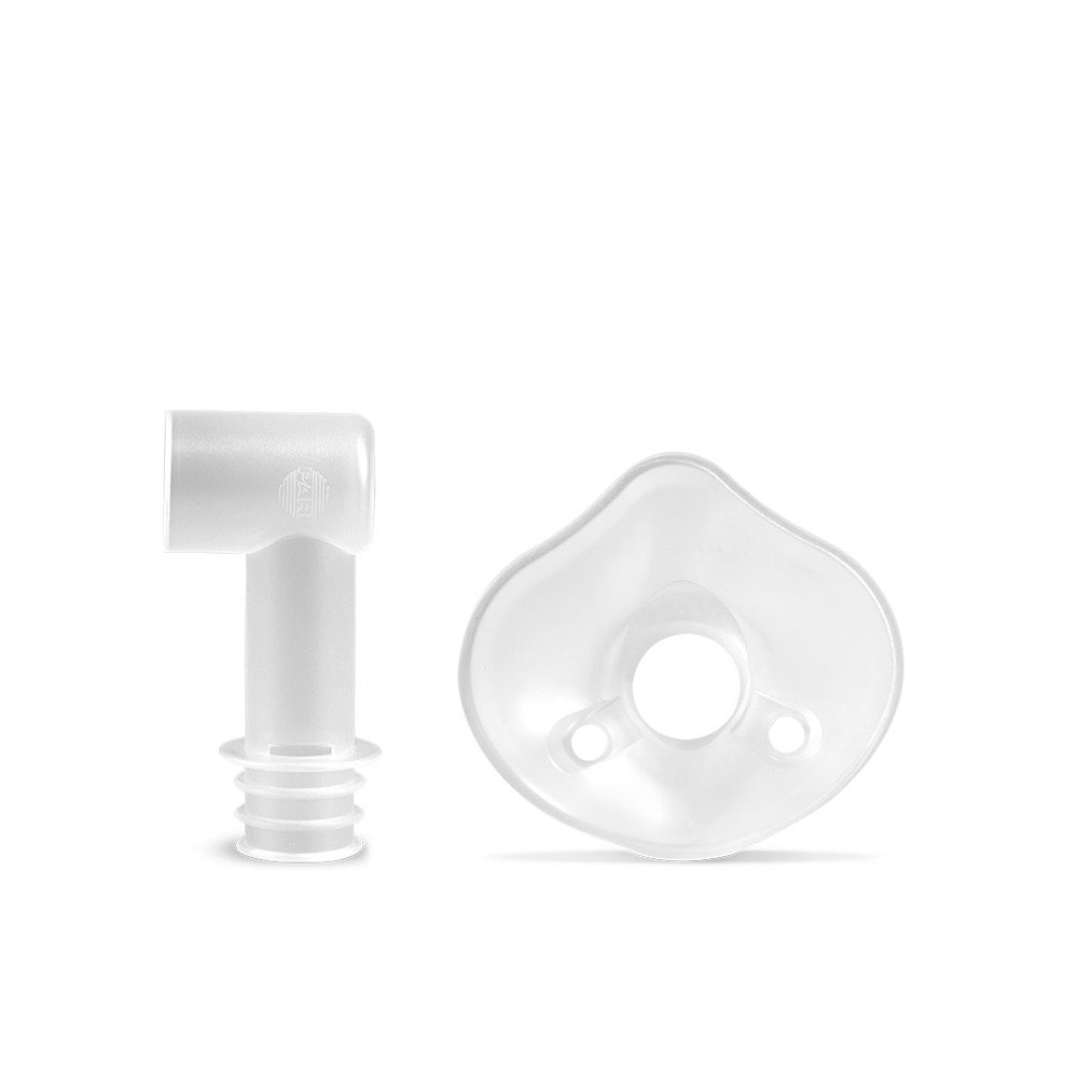Two clear plastic medical components, one L-shaped connector and one rounded mask with a central hole.