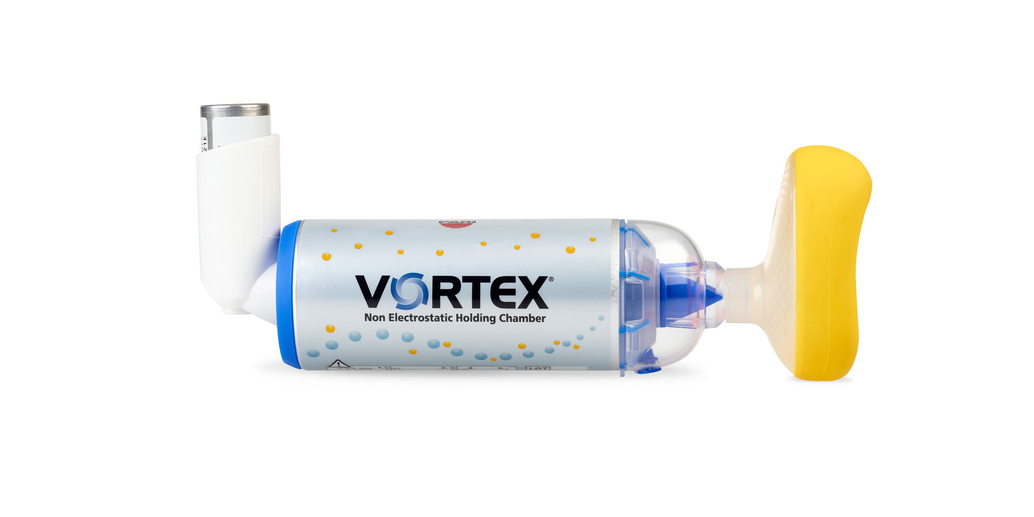 Vortex non-electrostatic holding chamber with inhaler and yellow mask, used for asthma treatment.