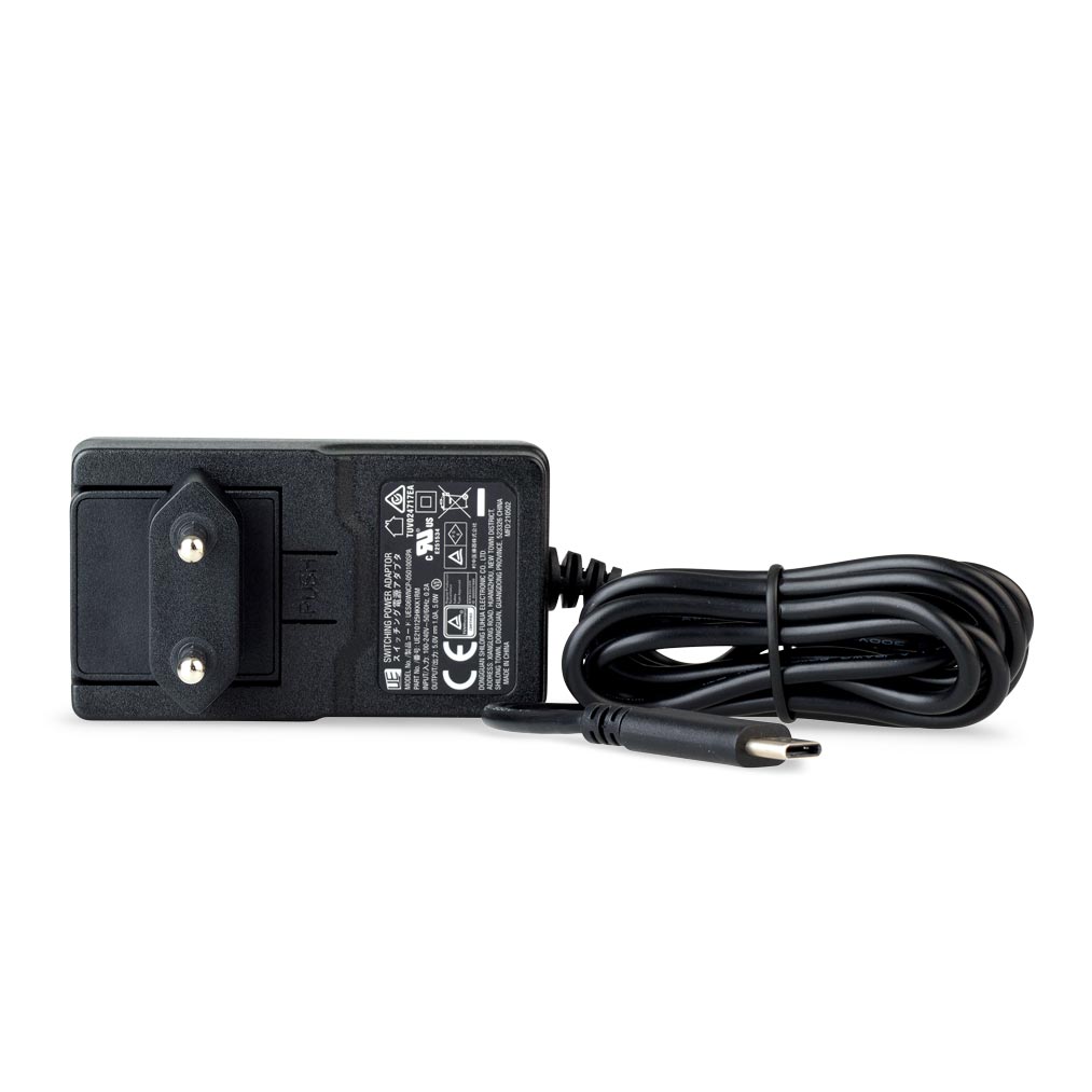 Black AC power adapter with a coiled cable and plug, viewed from the back, showing technical labels.
