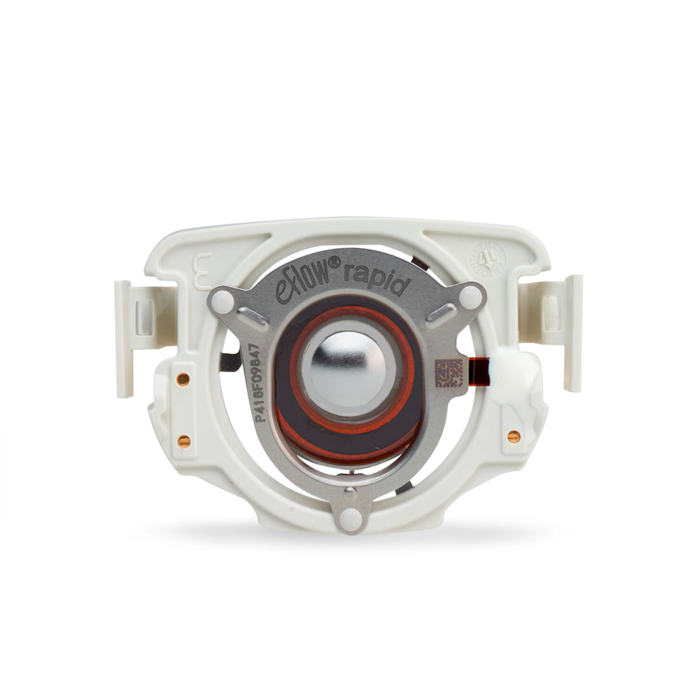 A white and silver eFlow rapid nebulizer part with a circular metal center and orange ring.
