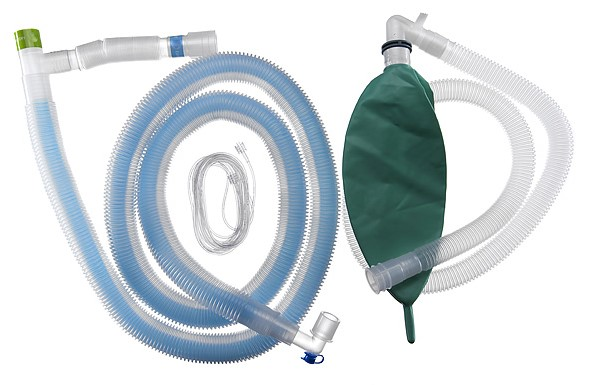 Medical breathing circuit set with corrugated tubes and a green reservoir bag on a white background.