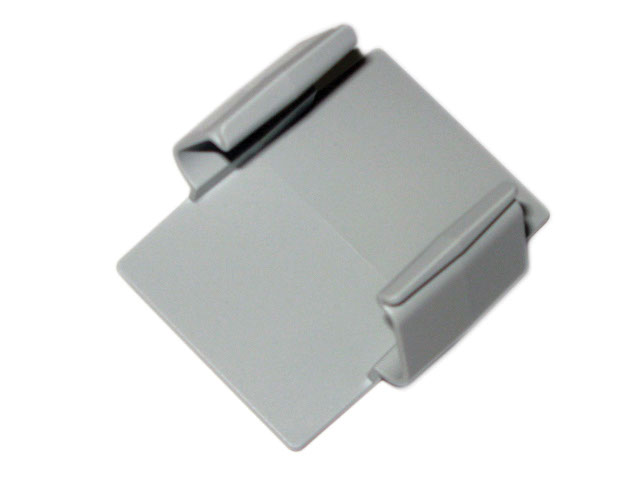 Gray plastic rectangular clip with two raised edges, placed on a white background.