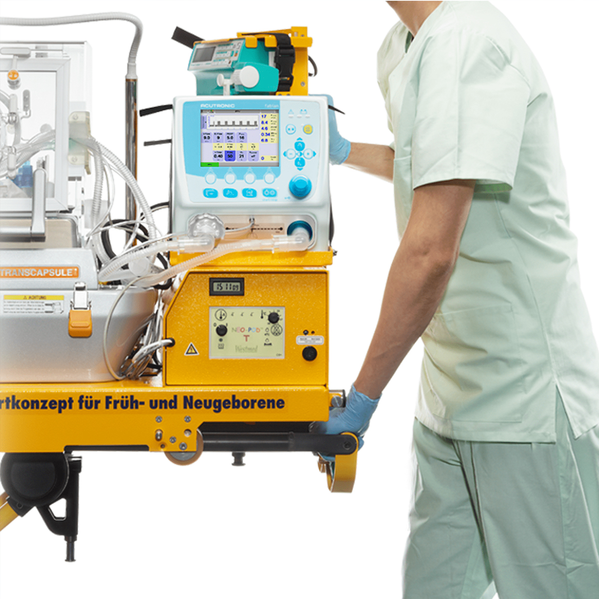 Medical staff in light scrubs moving a neonatal intensive care incubator with various monitoring devices.