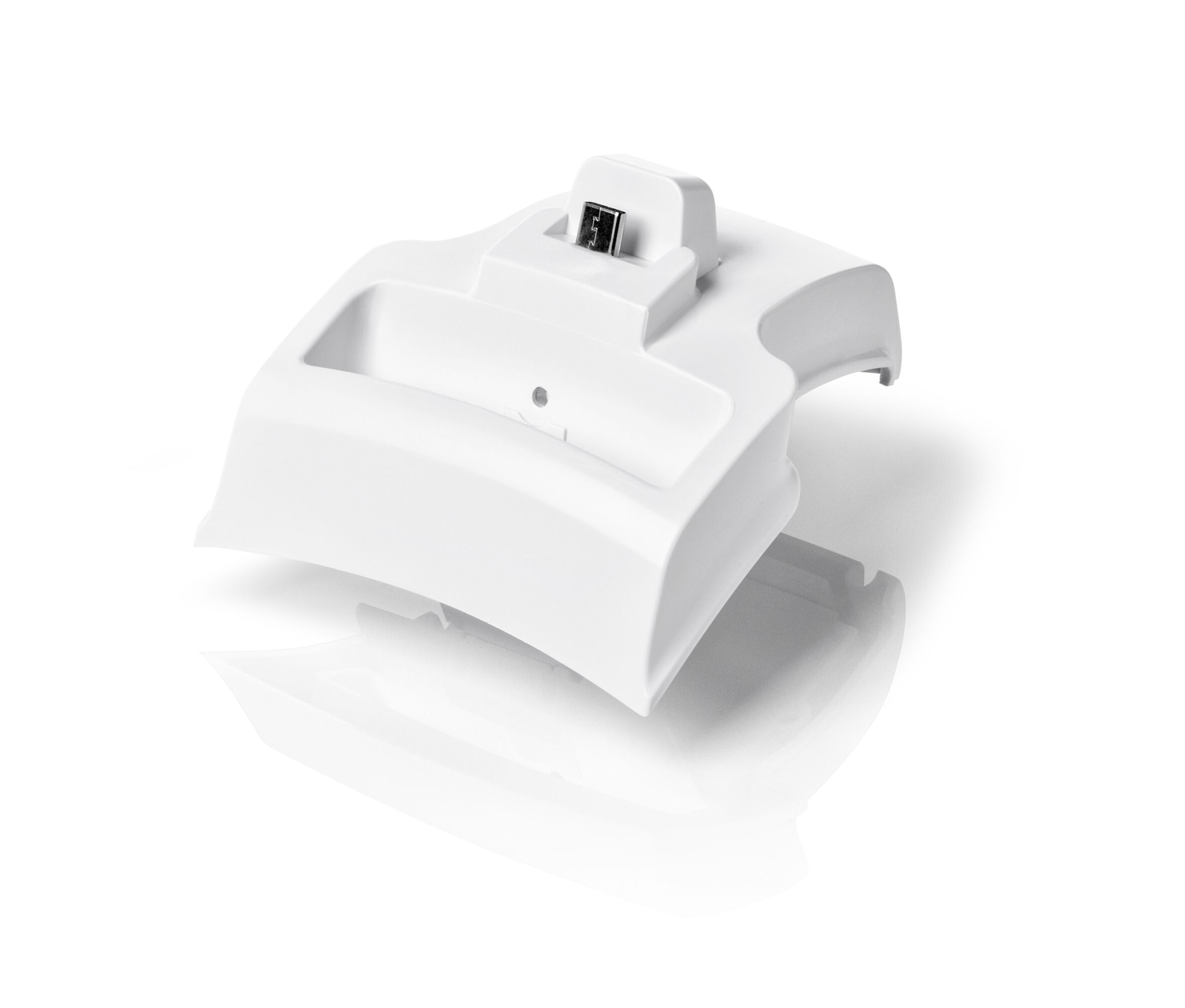 White plastic charging dock with a small connector on top, isolated on a white background.