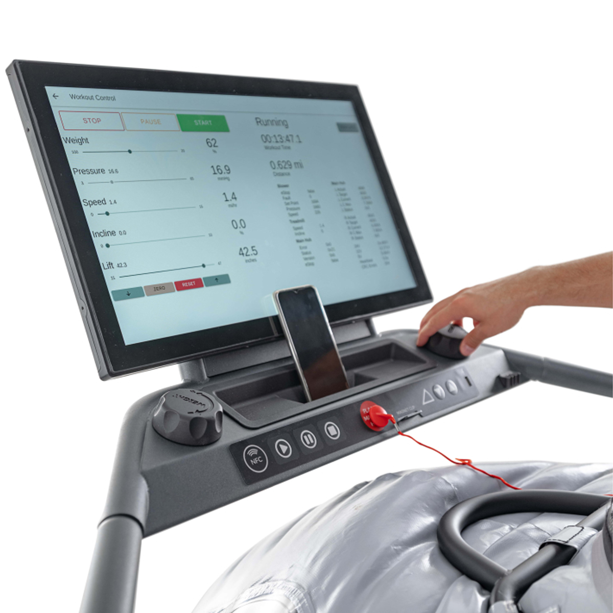 Hand using a treadmill control panel with a large display screen and various workout settings shown.