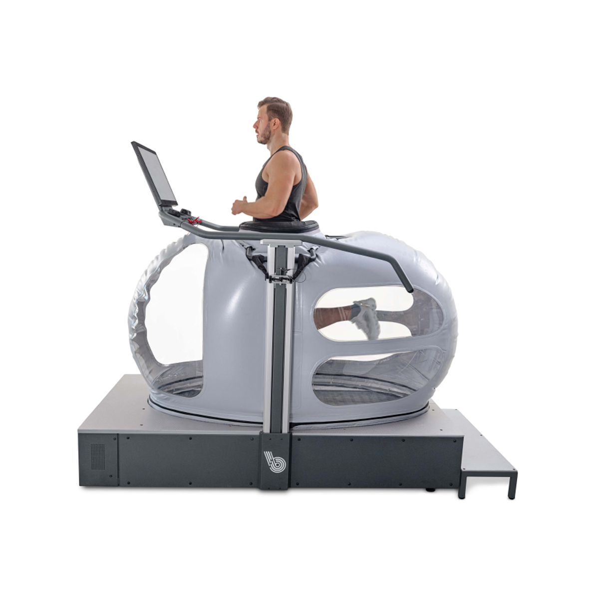 A man runs inside an anti-gravity treadmill with a transparent chamber and a digital display screen.
