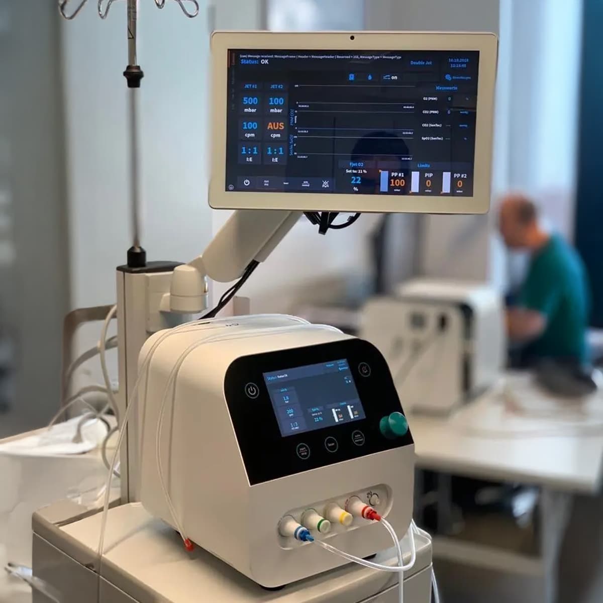 Modern medical ventilator with digital screens displaying patient data in a clinical setting.